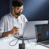 Joyroom GaN charger with retractable-style cable setup powering two laptops, shown in official product artwork