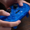 8BitDo Pro 2 Bluetooth controller with translucent blue shell, dual analog sticks and D-pad