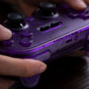 8BitDo Pro 2 Bluetooth controller with translucent purple shell, dual analog sticks and D-pad