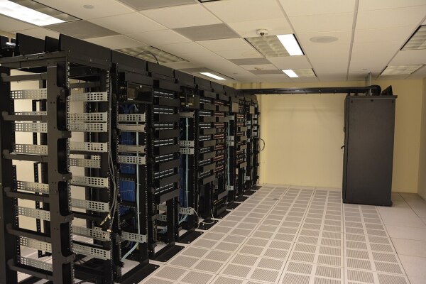 Rows of server racks in a data centre, illustrating the physical infrastructure used for cloud computing and AI workloads